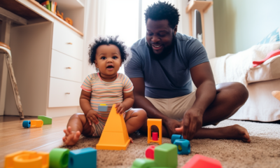 A group of fathers gathered in a brightly lit playroom, surrounded by toys and children of various ages. Some fathers are chatting while others are engaged in play with the kids. It's a scene of joy and bonding as fathers take on the role of caregiver for their children.